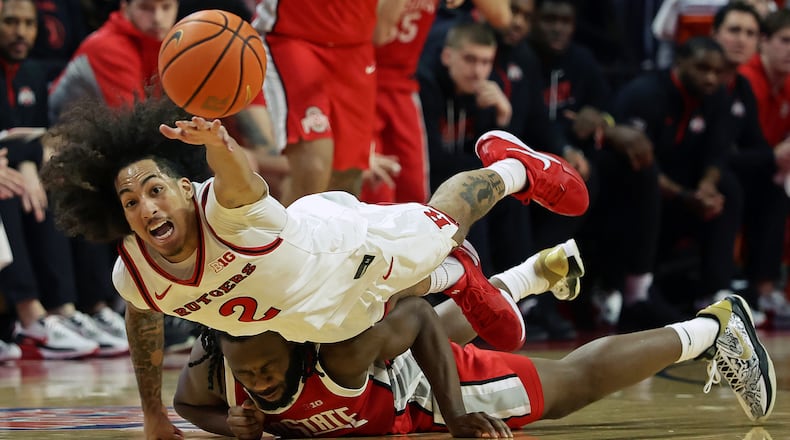 Rutgers guard Lino Mark (2) dives for a loose ball over Ohio State guard Bruce Thornton during the second half of an NCAA college basketball game Friday, Jan. 2, 2026, in Piscataway, N.J. (AP Photo/Adam Hunger)