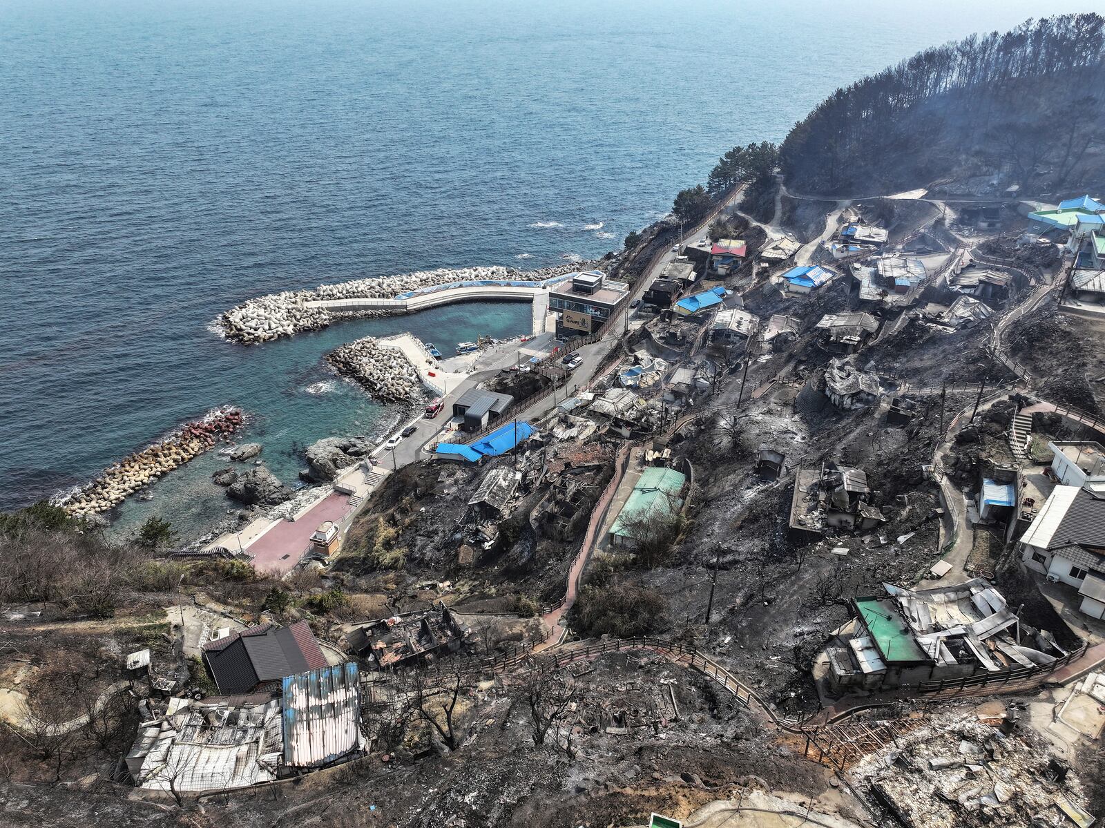 Burnt-out houses are seen at a damaged village due to wildfires in Yeongdeok, South Korea, Wednesday, March 26, 2025. (Yun Kwan-shik/Yonhap via AP)