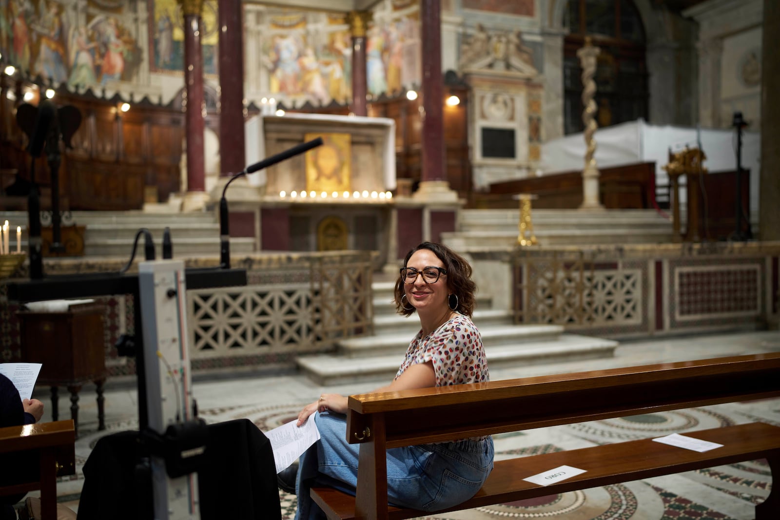 Lisa Remondino, chorus director, poses for a photo before the start of a mass in Santa Maria in Trastevere church in central Rome, Sunday, May 4, 2025. (AP Photo/Alessandra Tarantino)