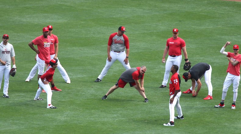 Reds relievers stretch before a game against the Cardinals on Thursday, Aug. 15, 2019, at Great American Ball Park in Cincinnati.