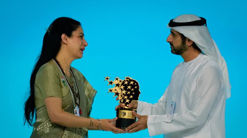 Indian teacher Rouble Nagi, left, receives the Global Teacher Prize trophy from Dubai Crown Prince Sheikh Hamdan bin Mohammed Al Maktoum, at a ceremony in Dubai, United Arab Emirates, Thursday, Feb. 5, 2026. (AP Photo/Altaf Qadri)