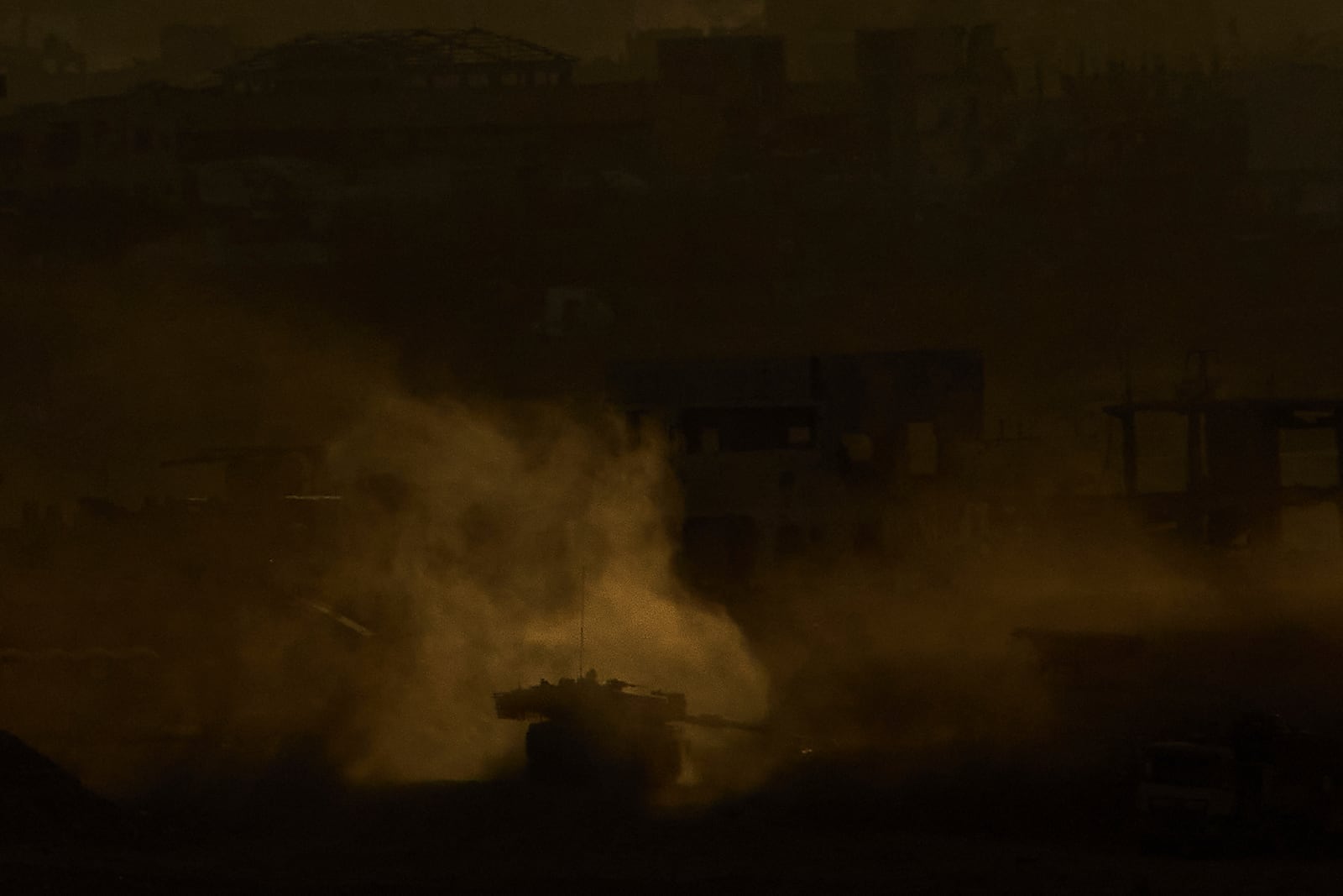 An Israeli army tank maneuvers in the Gaza Strip is seen from southern Israel, Sunday, May 4, 2025. (AP Photo/Ariel Schalit)
