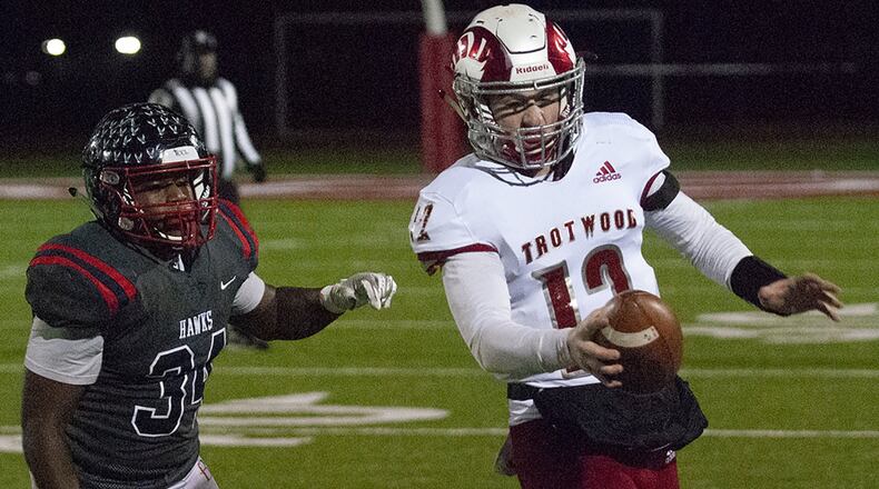 Trotwood quarterback Cooper Stewart is chased out of bounds during the first half of the Rams’ Division III state semifinal against Columbus Bishop Hartley on Friday at London High School. Jeff Gilbert/CONTRIBUTED