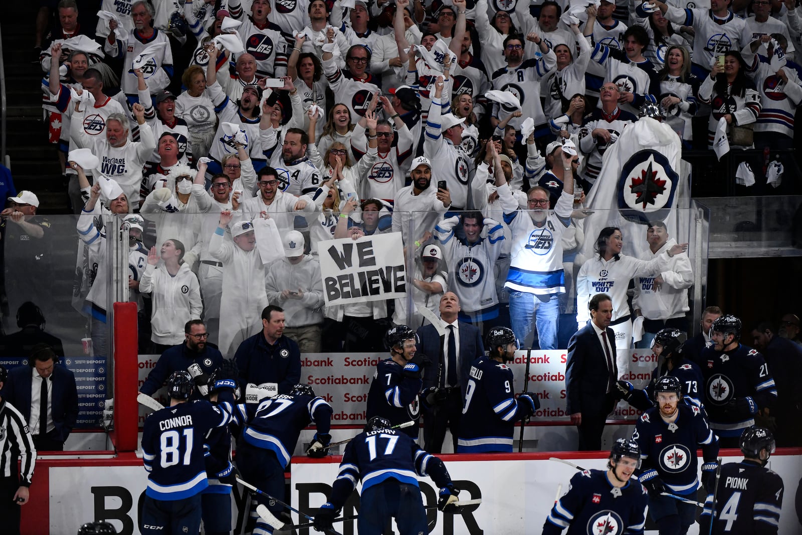 Winnipeg Jets fans celebrate after the team's third goal against the St. Louis Blues, during the third period of Game 7 in an NHL hockey first-round playoff series in Winnipeg, Manitoba, Sunday, May 4, 2025. (Fred Greenslade/The Canadian Press via AP)
