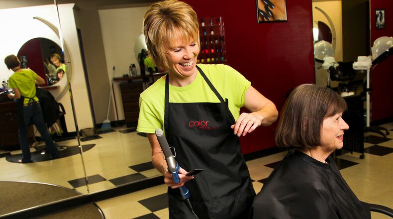 Lynne Tufts, stylist and co-owner of Tufts of Hair, finishes Janet Chase’s haircut and style Tuesday, June 12, 2012, at the shop along Central Avenue in Middletown, Ohio. Staff photo by Nick Daggy