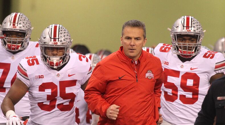 Ohio State’s Urban Meyer leads the team onto the field before a game against Wisconsin on Dec. 2, 2017, at Lucas Oil Stadium in Indianapolis. David Jablonski/Staff