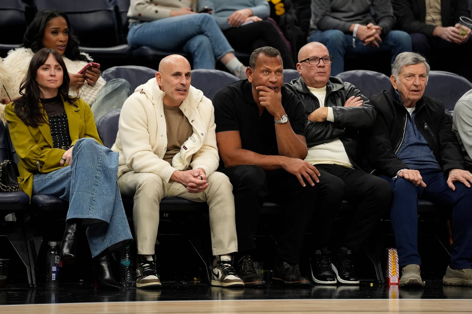 FILE - Minnesota Timberwolves minority owners Marc Lore, middle left, and Alex Rodriguez, middle right, watch during the second half of an NBA basketball game against the New York Knicks, Dec. 19, 2024, in Minneapolis. (AP Photo/Abbie Parr, File)