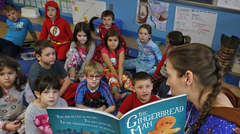 First grade students at Graham Elementary gather around their teacher for story time Friday, Dec. 15, 2017. Bill Lackey/Staff