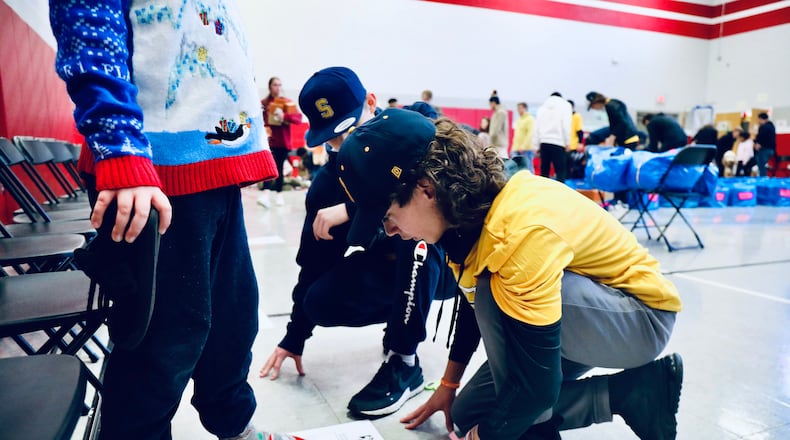 Horace Mann Elementary School held a Holiday Extravaganza before students were released for winter break on Wednesday in partnership with Shoes 4 The Shoeless, where nearly 200 students were given shoes and socks. Contributed/Springfield City School District