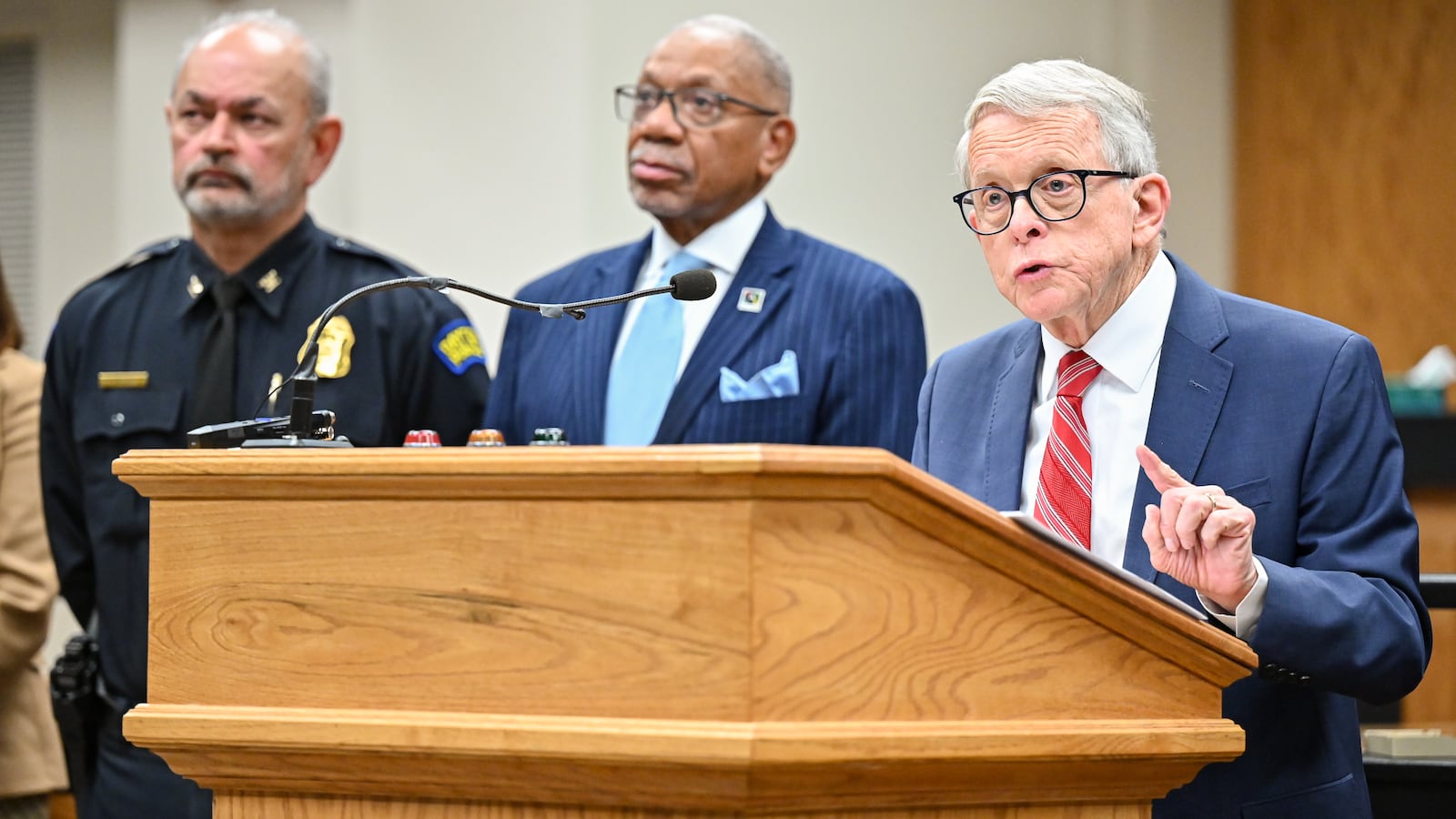 Gov. Mike DeWine (right) speaks while Dayton police Chief Kamran Afzal (left) and Dayton Mayor Jeffrey Mims Jr. listen during a news conference on Monday, Dec. 1 at Dayton City Hall. DeWine said the state is putting more resources toward fighting violent crime in Dayton. BRYANT BILLING/STAFF