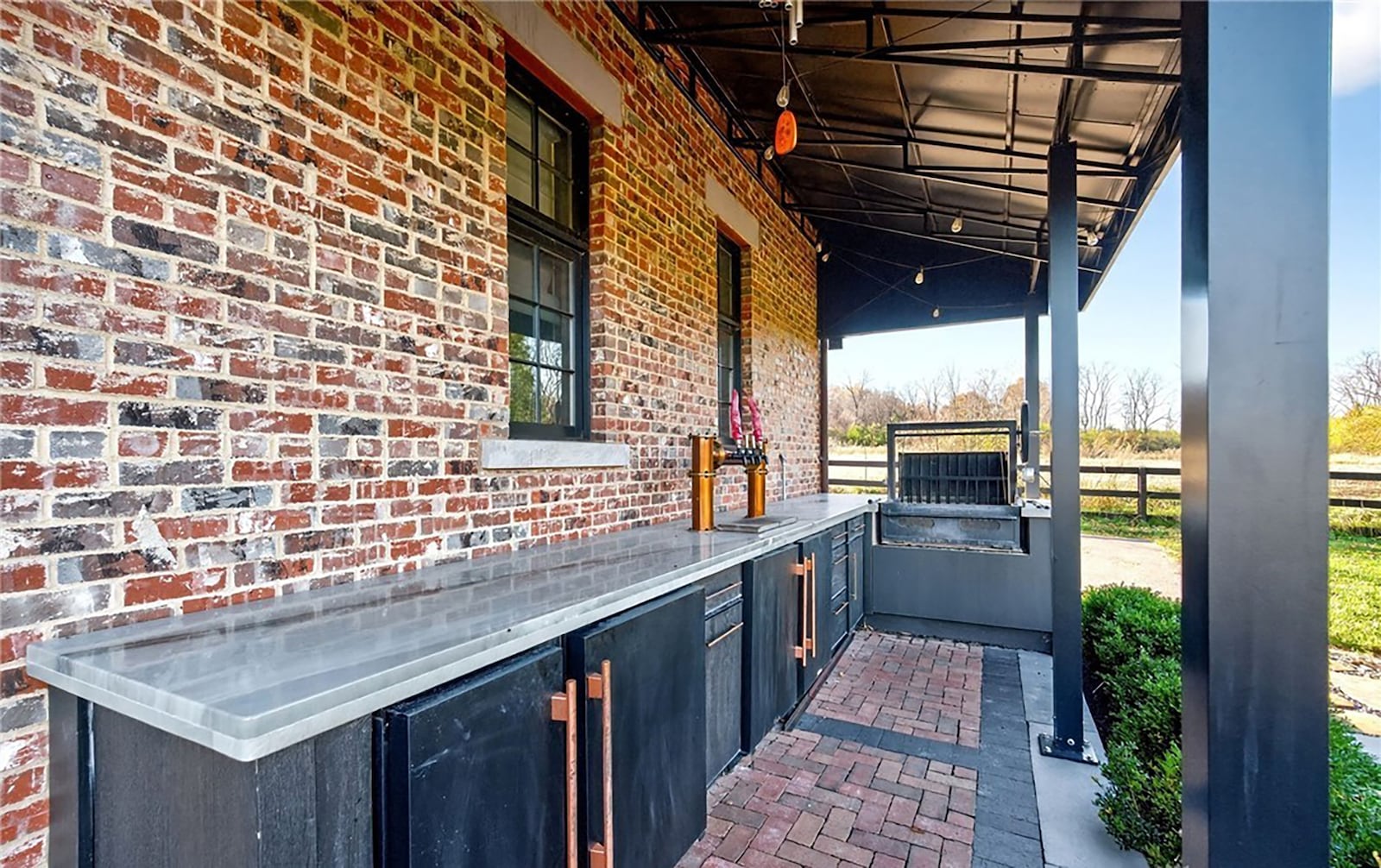 There is an outdoor kitchen with refrigerator, grill, ice maker and beer taps. It is covered with a tin roof. CONTRIBUTED