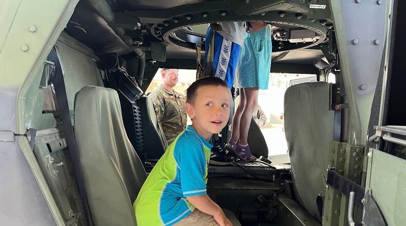 Emmett Cuccia, 4, could be seen climbing aboard a Humvee in a Wright-Patterson Air Force Base hangar at Operation K.U.D.O.S Friday morning. The event was meant to give children insights into life in military deployment for their active-duty parents. THOMAS GNAU/STAFF