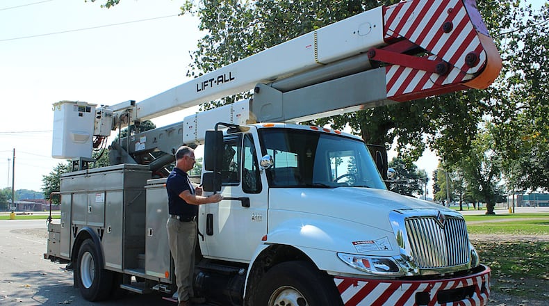 Clark County Fairgrounds Executive Director Dean Blair looks over a bucket truck donated by Ohio Edison First Energy Foundation. JEFF GUERINI/STAFF