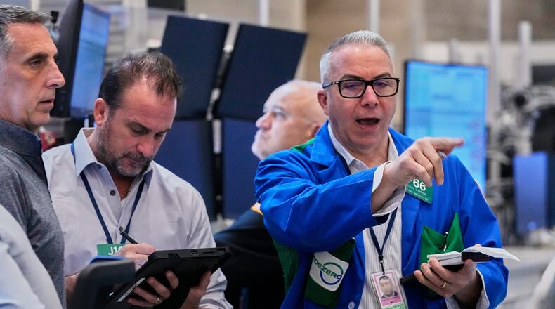 Options traders Joseph Arrigo, right, works on the floor of the New York Stock Exchange, Monday, Oct. 20, 2025. (AP Photo/Richard Drew)