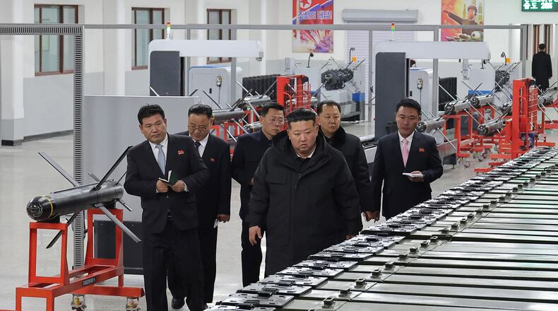 In this photo provided by the North Korean government, its leader Kim Jong Un, front right, visits a major munitions factory at an undisclosed place in North Korea Saturday, Jan. 3, 2026. Independent journalists were not given access to cover the event depicted in this image distributed by the North Korean government. The content of this image is as provided and cannot be independently verified. (Korean Central News Agency/Korea News Service via AP)
