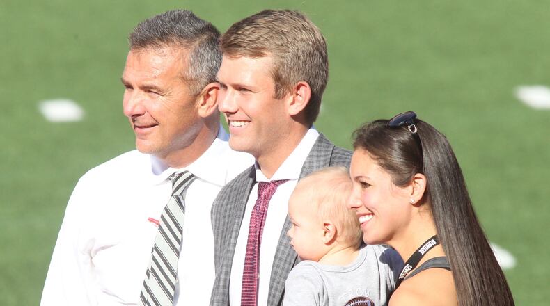 Ohio StateÃs Urban Meyer poses for a photo with son-in-law Corey Dennis, grandson Troy and daughter Nicki Meyer Dennis after arriving at Ohio Stadium before a game against UNLV  on Saturday, Sept. 23, 2017, in Columbus. David Jablonski/Staff