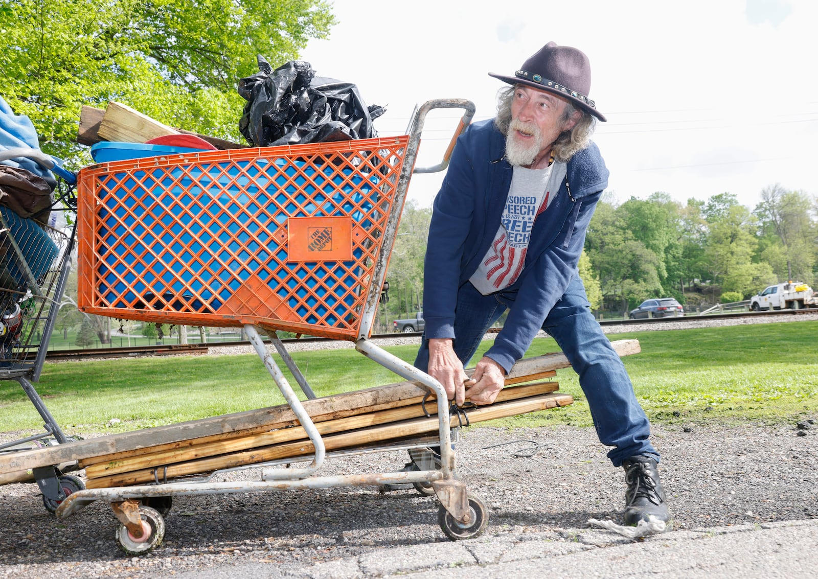 A man identified as "Thomas" sorts his belongings as he leaves a homeless encampment on Monday, May 5, 2025, at Snyder Park. He lived there for a year and a half. JOSEPH COOKE/STAFF
