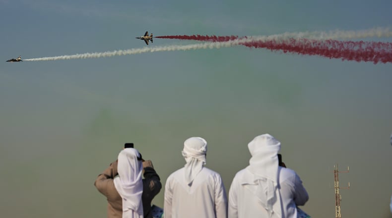 Emirati men take photos of Fursan Al Emarat, the aerobatics demonstration team of the United Arab Emirates Air Force during the Dubai Air Show in Dubai, United Arab Emirates, Tuesday, Nov. 18, 2025. (AP Photo/Fatima Shbair)