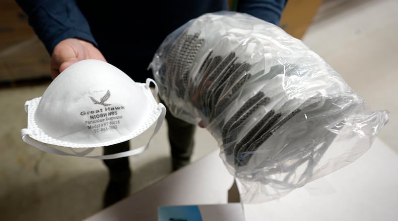 Grocery stores and pharmacies in the Dayton area are giving away free N95 masks as part of a federal program. (AP Photo/Charles Krupa)