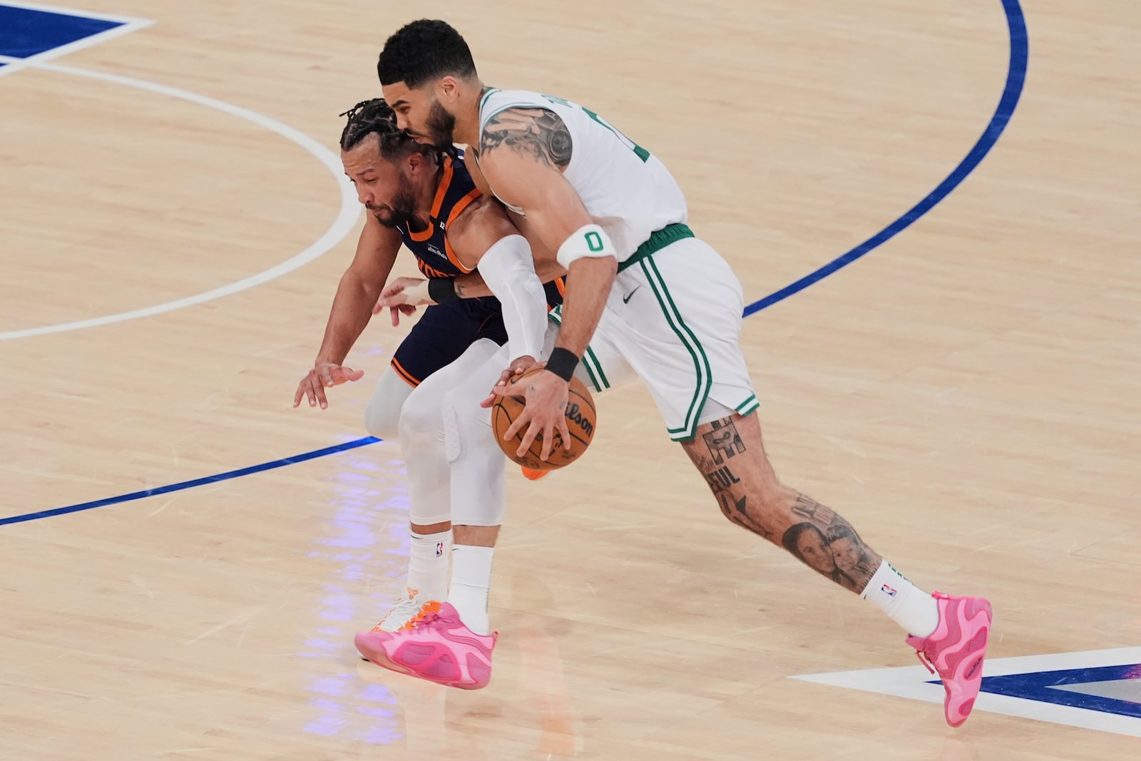 New York Knicks' Jalen Brunson, left, defends Boston Celtics' Jayson Tatum, right, during the first half of Game 4 in the Eastern Conference semifinals of the NBA basketball playoffs Monday, May 12, 2025, in New York. (AP Photo/Frank Franklin II)