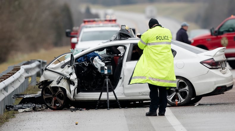 FILE - In this Saturday, Jan. 25, 2020, file photo, emergency crews work the scene of a fatal crash involving a charter bus and car on the AA highway in Campbell County, Ky. The driver of the vehicle died. The number of people killed on the nation’s highways rose 4.6% in the first nine months of 2020, despite coronavirus lockdowns that curtailed driving early in the year. (Albert Cesare/The Cincinnati Enquirer via AP, File)
