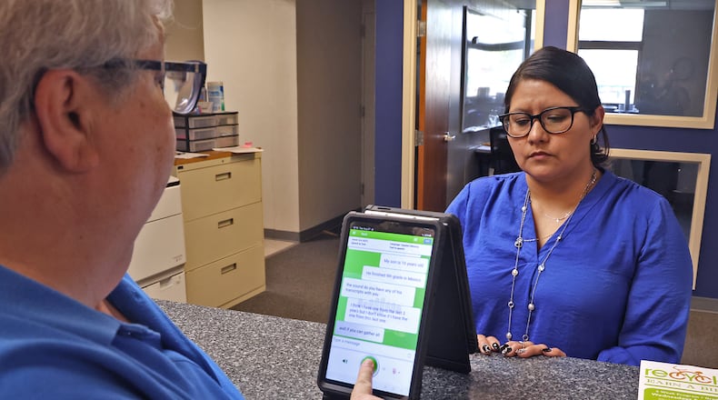 Dr. Pamela Shay and Lydia Martinez uses one of the Translate Live devices to have a conversation in the Springfield School District's central registration office Tuesday, August 27, 2024. BILL LACKEY/STAFF