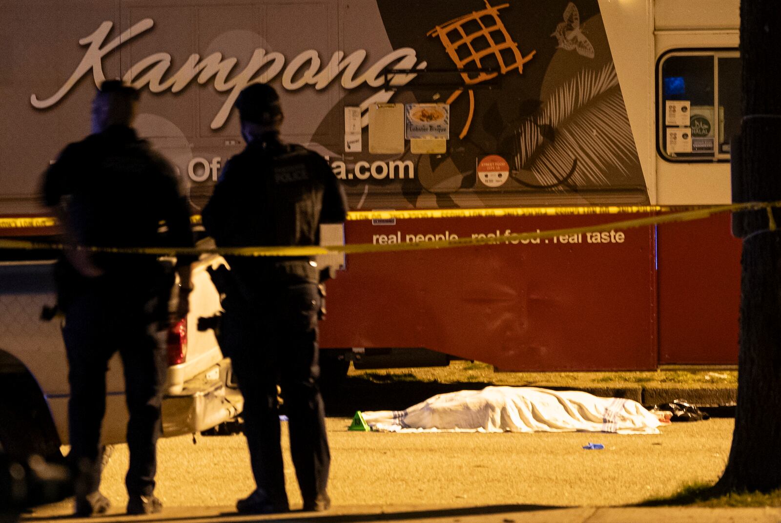 A victim covered with a cloth lies near a food truck after a car drove into a crowd at the Lapu Lapu Festival in Vancouver, British Columbia, Saturday April 26, 2025. (Rich Lam/The Canadian Press via AP)