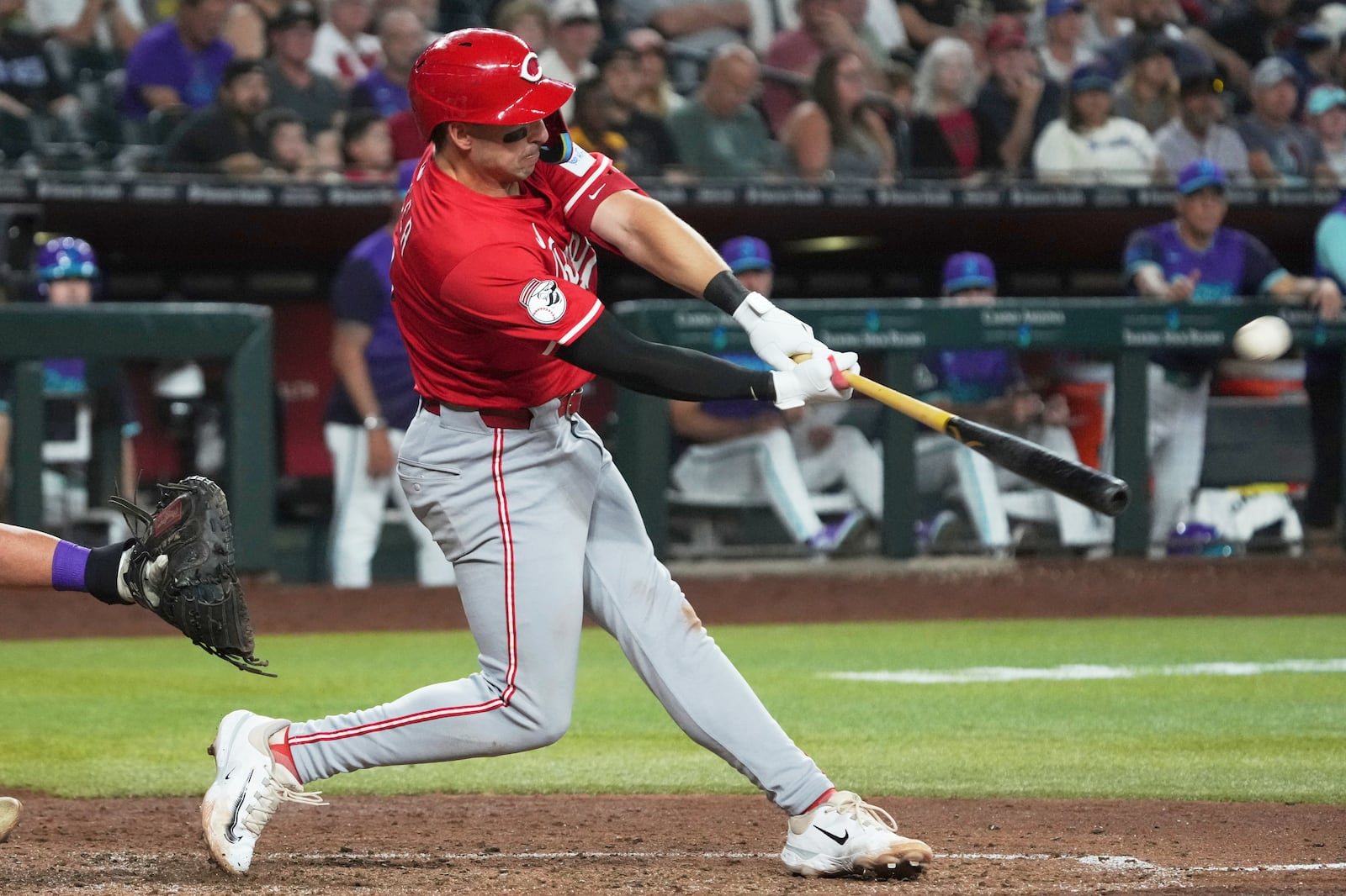 Cincinnati Reds' Spencer Steer hits a three-run home run against the Arizona Diamondbacks in the eighth inning of a baseball game Sunday, Aug 24, 2025, in Phoenix. (AP Photo/Rick Scuteri)