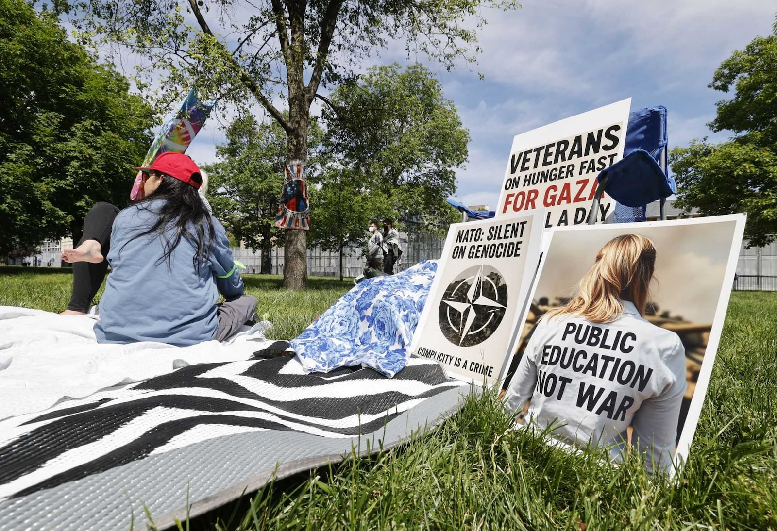 Protestors gathered at Cooper Park behind the Dayton Metro Library Main Branch down the street from the NATO Parliamentary Assembly happening in downtown Dayton on Saturday, May 24, 2025. NICK GRAHAM / STAFF