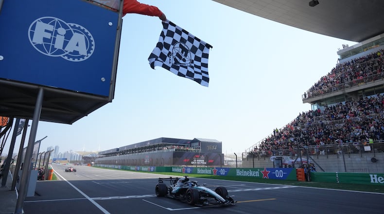 Mercedes driver George Russell of Britain crosses the finish line and wins the Sprint Race of the Chinese Formula One Grand Prix at the Shanghai International Circuit, in Shanghai, China, Saturday, March 14, 2026. (AP Photo/Andy Wong, Pool)