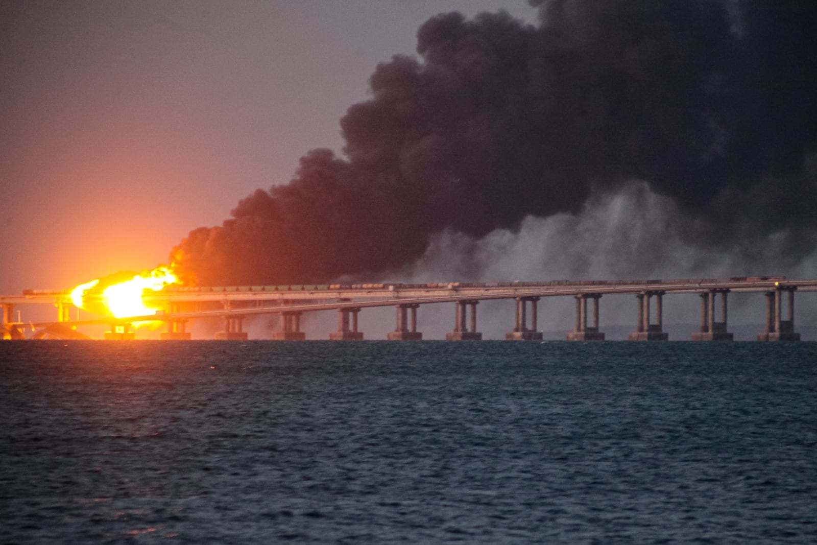 FILE - Flames and smoke rise from a bridge connecting Crimea and Russia in Kerch, on the Crimean peninsula, Oct. 8, 2022. (AP Photo, File)