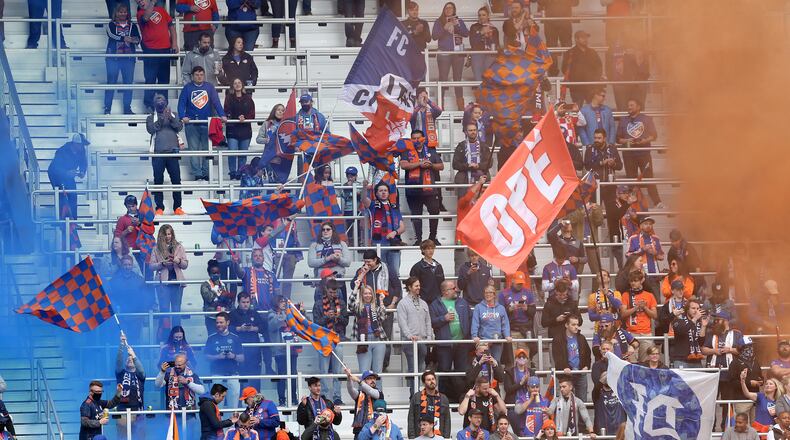 FC Cincinnati fans cheer on the team against the New England Revolution during the first half of an MLS soccer match, Saturday, May 29, 2021, at TQL Stadium in Cincinnati. (Kareem Elgazzar/The Cincinnati Enquirer via AP)