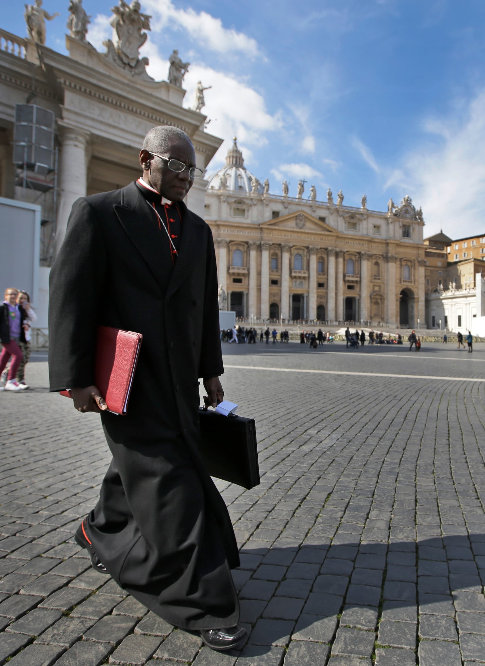 FILE - In this March 4, 2013 file photo, Cardinal Robert Sarah, of Guinea, walks in St. Peter's Square after attending a cardinals' meeting, at the Vatican. (AP Photo/Andrew Medichini, File)