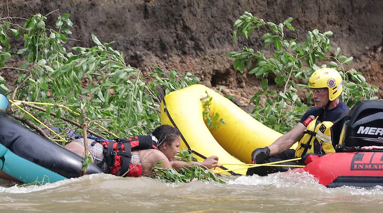 Four people had to be rescued from a fallen tree in the middle of the Mad River Monday, June 13, 2022. Fire departments from the City of Springfield, German Township and Mad River Township responded to the scene where four people had been tubing and became stranded in the swift moving water. German Township and Mad River Township used boats to rescue the victims, who were stranded between Eagle City Road and St. Paris Pike. BILL LACKEY/STAFF