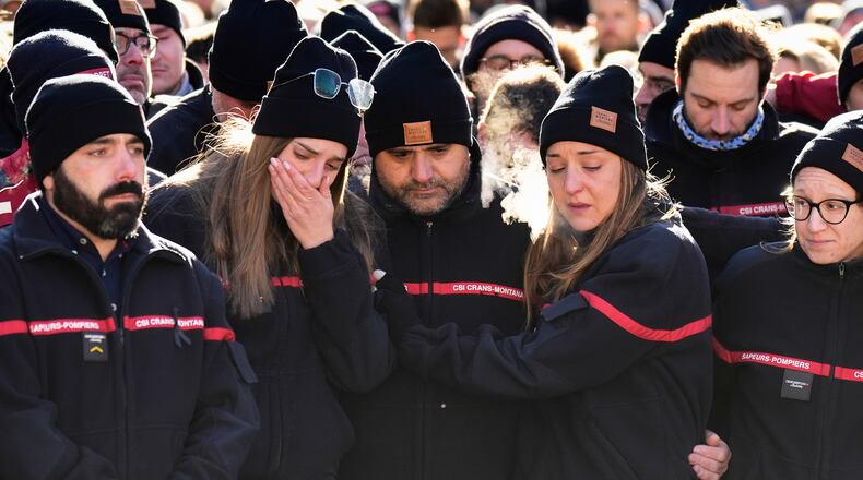 Firefighters cry as they attend a memorial march in Crans-Montana, Swiss Alps, Switzerland, Sunday, Jan. 4, 2026, after a devastating fire in Le Constellation bar left dead and injured during the New Year's celebrations. (AP Photo/Baz Ratner)