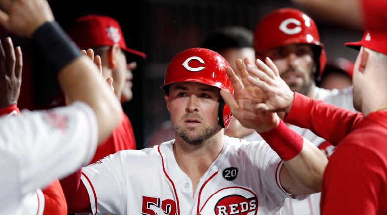 CINCINNATI, OH - JUNE 17: Kyle Farmer #52 and Curt Casali #12 of the Cincinnati Reds celebrate in the dugout after scoring runs in the fifith inning against the Houston Astros at Great American Ball Park on June 17, 2019 in Cincinnati, Ohio. The Reds won 3-2. (Photo by Joe Robbins/Getty Images)