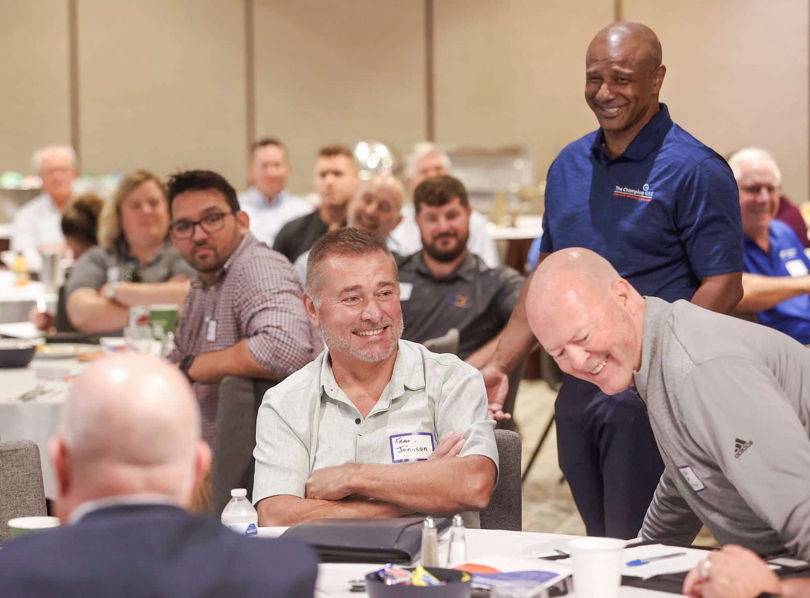 Frank Johnson, center, quality manager at Champion GSE, Gavin Constantine, back, director of supply chain at Champion GSE, and Cheldon Rose, sales manager at SK Mold & Tool, laugh at a joke during an event held by Champion GSE on Tuesday, October 7, 2025, at the Courtyard by Marriott Springfield Downtown. JOSEPH COOKE / STAFF