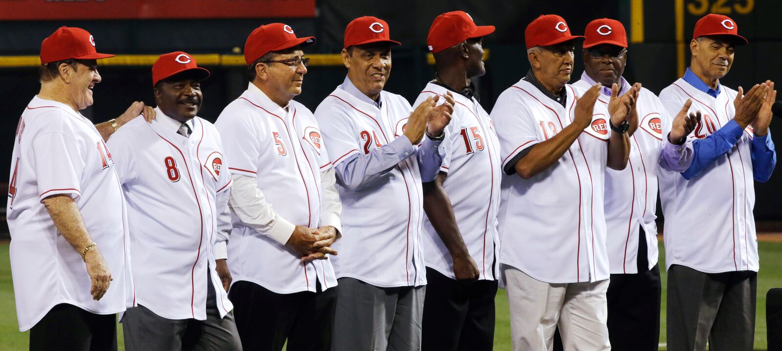 The starting eight of the 1975-76 World Series-winning Cincinnati Reds, left to right, Pete Rose, Joe Morgan, Johnny Bench, Tony Perez, George Foster, Dave Concepcion, Ken Griffey Sr., and Cesar Geronimo, line up during ceremonies honoring them following a baseball game between the Reds and the Los Angeles Dodgers, Friday, Sept. 6, 2013, in Cincinnati. (AP Photo/Al Behrman)
