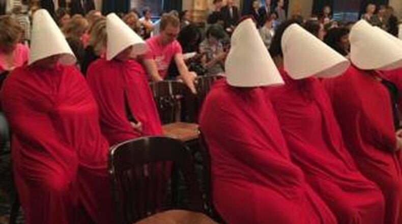 Women dressed in costume from The Handmaid s Tale protested a new bill in the Ohio Senate that would outlaw the most common surgery used in second trimester abortions. Photo by Jo Ingles/Statehouse News Bureau