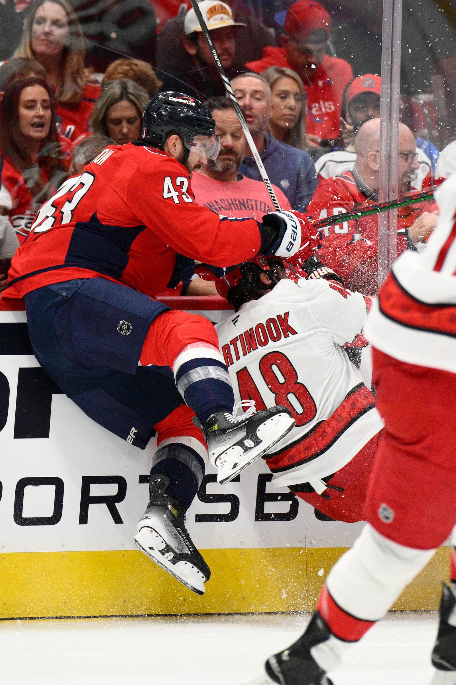 Washington Capitals right wing Tom Wilson (43) and Carolina Hurricanes left wing Jordan Martinook (48) collide in the first period of Game 2 of a second-round NHL hockey playoff series Thursday, May 8, 2025, in Washington. (AP Photo/Nick Wass)
