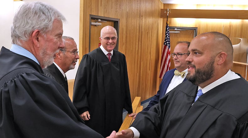 Brian Driscoll, right, shakes hands with other Clark County judges after being sworn in as a Municipal Court Judge in the file photo. BILL LACKEY/STAFF
