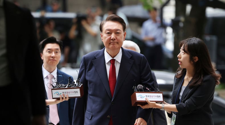 FILE - Former South Korean President Yoon Suk Yeol, center, arrives at a court to attend a hearing to review his arrest warrant requested by special prosecutors in Seoul, South Korea, July 9, 2025. (Kim Hong-Ji/Pool Photo via AP, File)