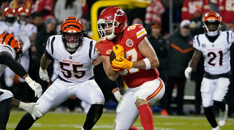 Kansas City Chiefs tight end Travis Kelce catches a pass as Cincinnati Bengals linebacker Logan Wilson (55) defends during the second half of an NFL football game Sunday, Dec. 31, 2023, in Kansas City, Mo. (AP Photo/Ed Zurga)