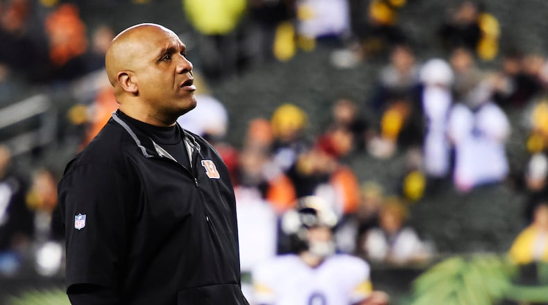 Cincinnati Bengals offensive coordinator Hue Jackson stand on the field prior to their18-16 loss to the Pittsburgh Steelers in the AFC wild card playoff game Saturday, Jan. 9 at Paul Brown Stadium in Cincinnati. NICK GRAHAM/STAFF