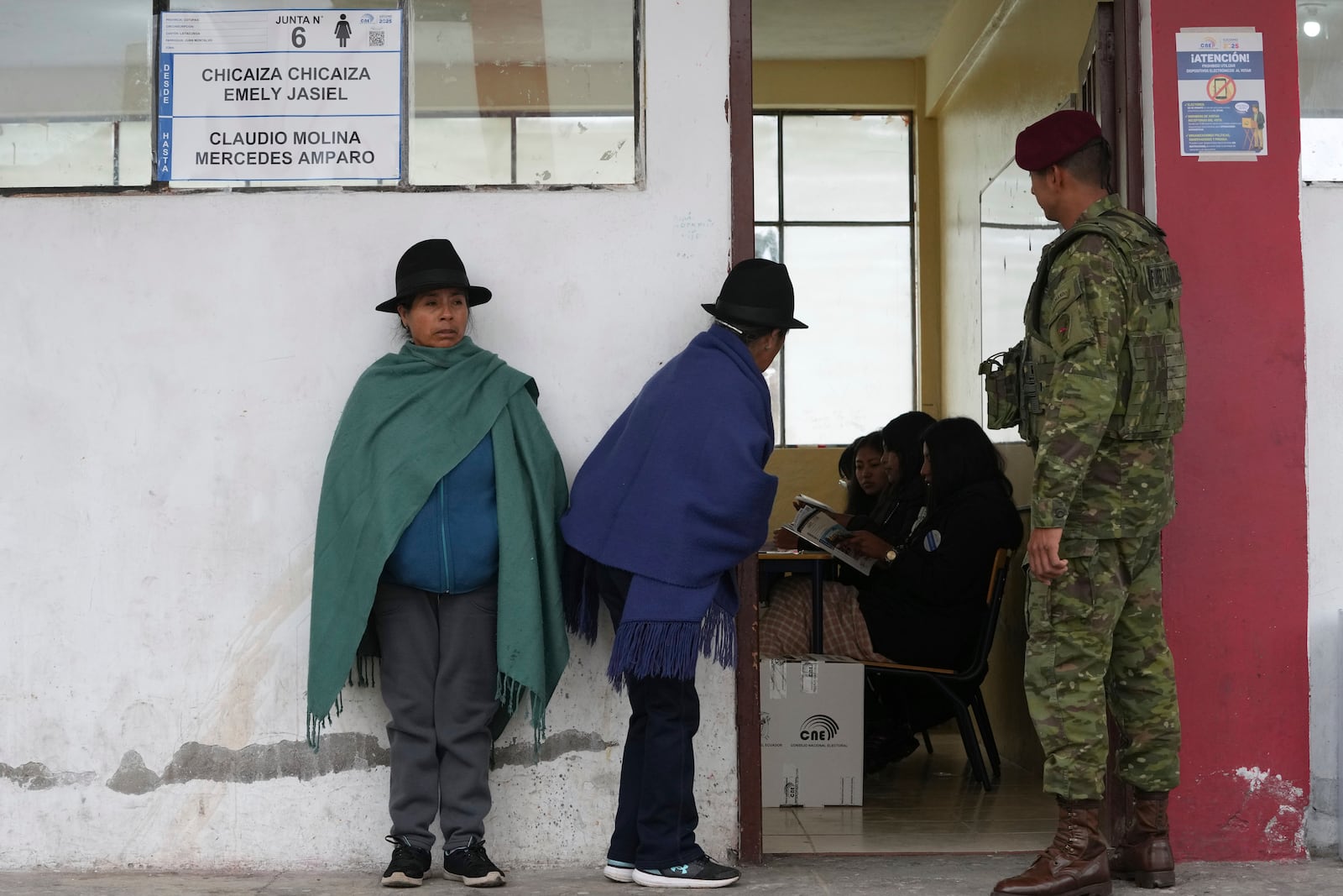 Women line up to vote in the presidential election runoff in Latacunga, Ecuador. Sunday, April 13, 2025. (AP Photo/Dolores Ochoa)
