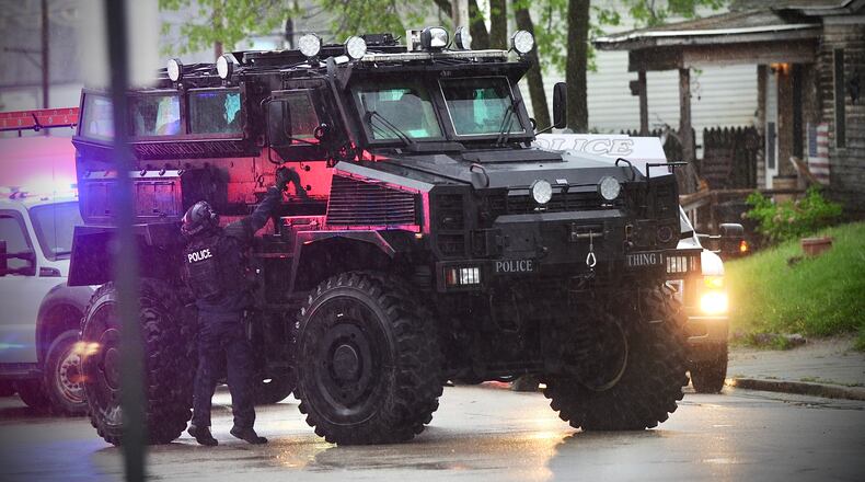 Members of the Springfield Police Division and SWAT team staged outside 905 Pleasant St., Friday evening May 6, 2022. MARSHALL GORBY \STAFF