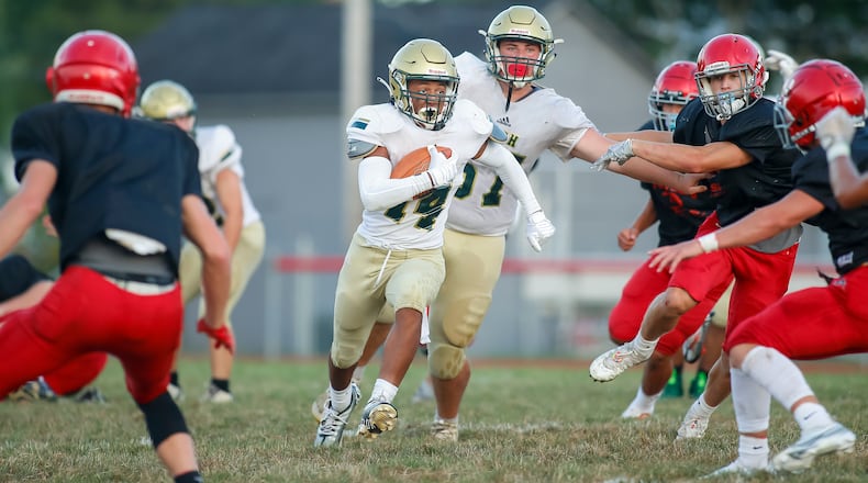 Catholic Central High School junior Daniel Kamara runs the ball during their scrimmage game against Twin Valley South last month. CONTRIBUTED PHOTO BY MICHAEL COOPER