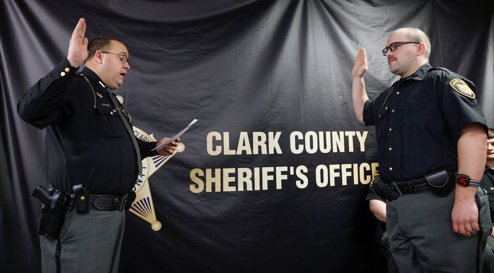 Deputy Thomas Schaefer, right, is sworn into the Clark County Sheriff’s Office by Sheriff Chris Clark on Monday, March 16, 2026, in Springfield. Schaefer was one of three deputies sworn in today. JOSEPH COOKE/STAFF