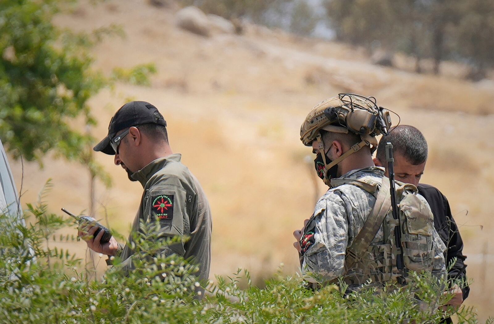 Forces of the regional Kurdish administration secure the area of the Jasana Cave ahead of a symbolic disarmament ceremony by the separatist PKK group as part of the peace process with Turkey, in Sulaymaniyah governorate, Iraq, Friday, July 11, 2025. (AP Photo/Hadi Mizban)