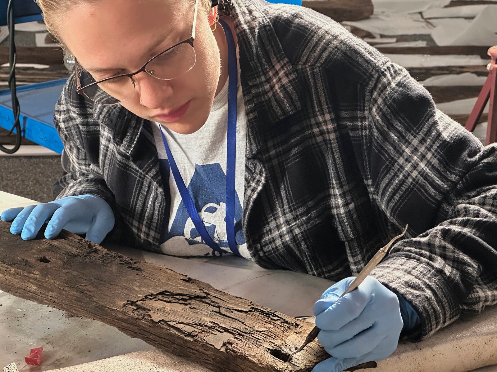 Research assistant Marissa Agerton cleans a piece of wood from a Revolutionary War-era gunboat to prepare for the craft's partial reconstruction at the New York State Museum, Friday, May 30, 2025, in Albany, New York. (AP Photo/Michael Hill)